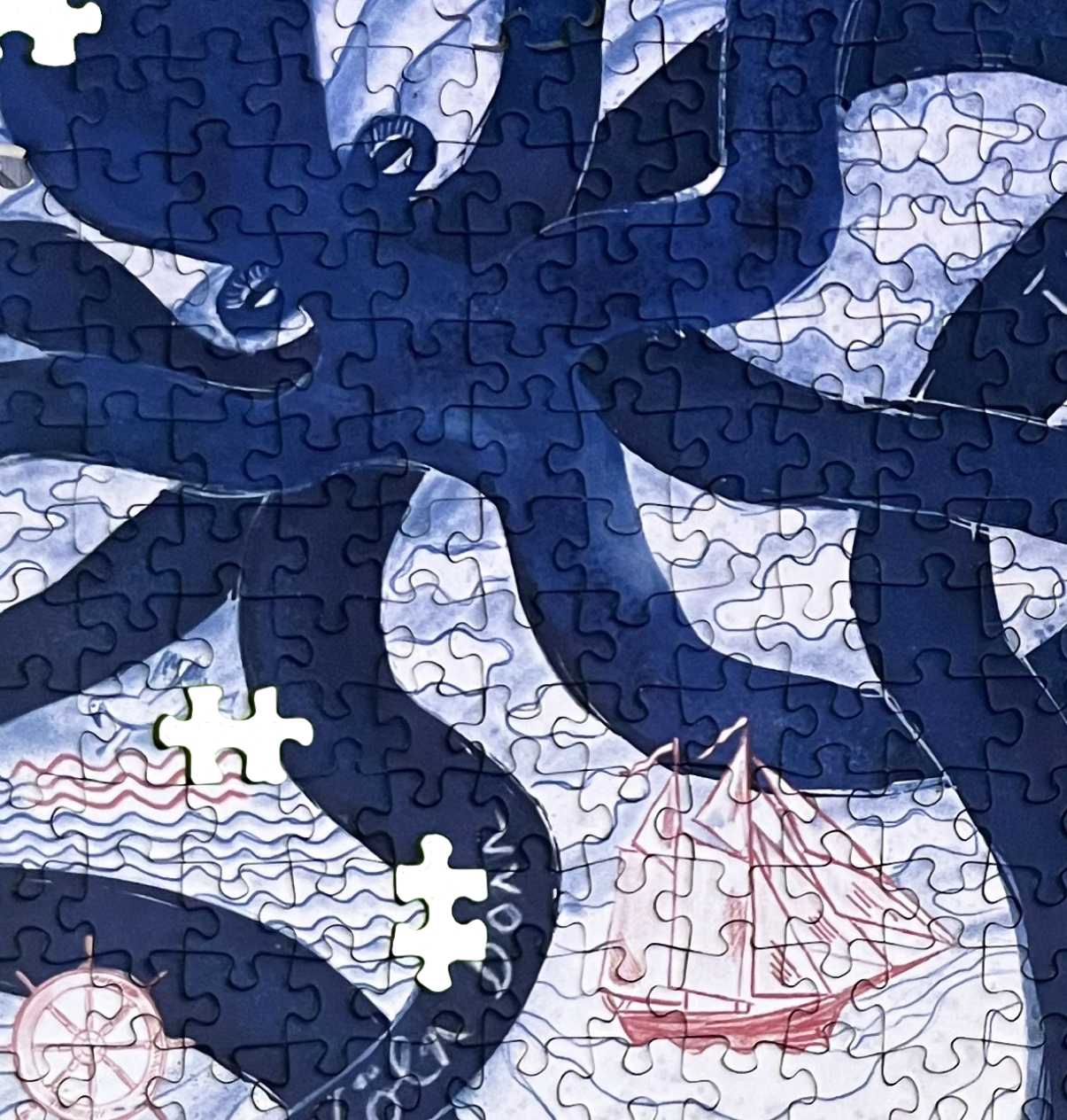 Puzzle Therapielotsen Festival Puzzle mit einem dunkelblauen Oktopus, der Tentakel um ein Segelschiff ausbreitet, zwei Puzzleteile fehlen